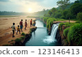 Children Walking by Scenic Waterfall at Sunset 123146413