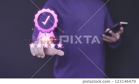 Person interacts with a digital five-star rating interface, symbolizing high-quality service. A checkmark badge emphasizes quality assurance, reflecting user satisfaction and trust in online platform. 123146479