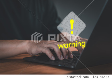 Person use a laptop with caution warning sign for notification error. Concept cyber security technology of computer virus detect, personal data protection, network security and maintenance. 123146483