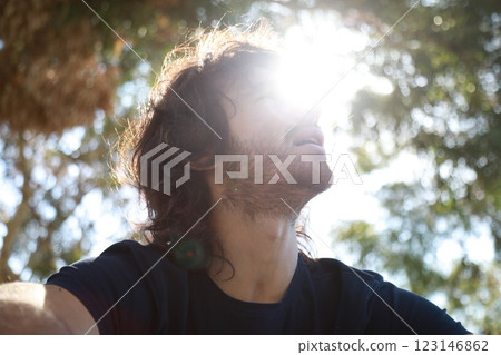 Pensive Long Hair Man Sitting On The Sidewalk Reflecting On Debts 123146862