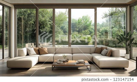 Modern sectional sofa in sunlit living room with large windows and garden view. Modern sectional sofa in sunlit living room with large windows and garden view. 123147154