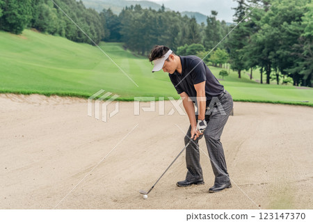 Male golfer hitting a bunker shot Male golfer hitting a bunker shot 123147370