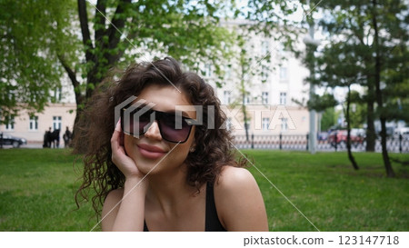 Beautiful woman portrait in a city park in summertime Beautiful woman portrait in a city park in summertime 123147718