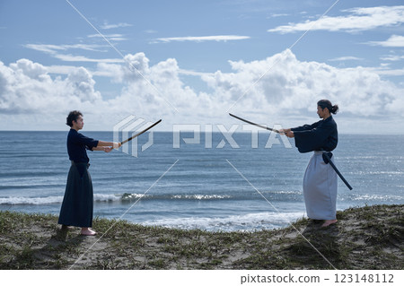 Two samurai facing off on the beach 123148112