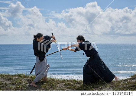 Two samurai facing off on the beach Two samurai facing off on the beach 123148114