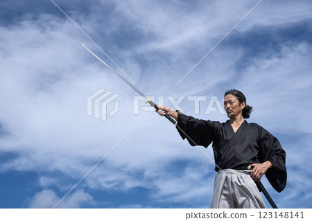 A middle-aged man in a kimono pulling out his sword A middle-aged man in a kimono pulling out his sword 123148141