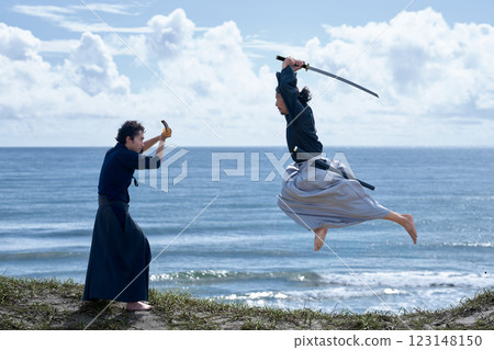 Two samurai facing off on the beach Two samurai facing off on the beach 123148150