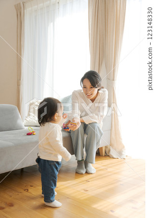 Girl and mom relaxing in the living room Girl and mom relaxing in the living room 123148330