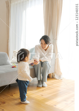 Girl and mom relaxing in the living room Girl and mom relaxing in the living room 123148331