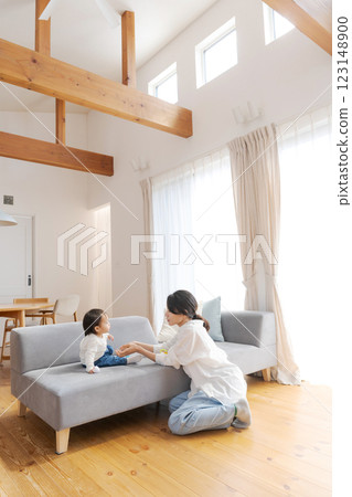 Girl and mom relaxing in the living room 123148900