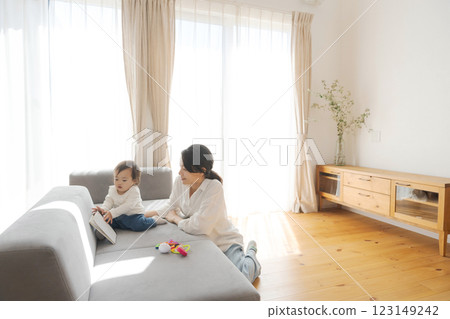 Girl and mom relaxing in the living room 123149242