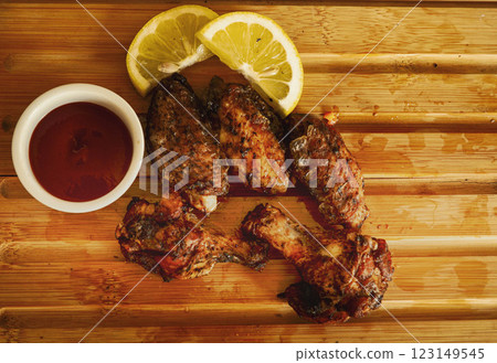 Juicy Grilled Chicken with Tangy Red Saucecook in air fryer two slides of lemon Juicy Grilled Chicken with Tangy Red Saucecook in air fryer two slides of lemon 123149545