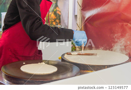 Man in Process making Street Food Pancake Perfection Man in Process making Street Food Pancake Perfection 123149577