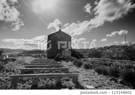 Historic Chapel Church with Outdoor Benches, Lush Greenery, and Peaceful Atmosphere 123149602