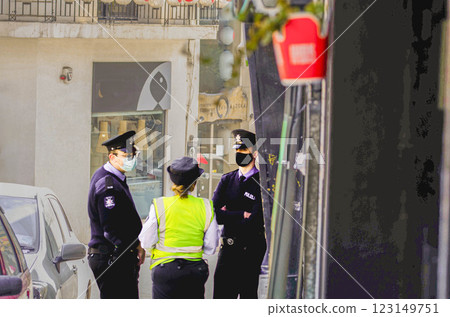 Police officers on duty discussing in a city street, enforcing law and security Police officers on duty discussing in a city street, enforcing law and security 123149751