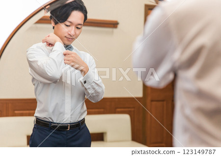 Groom/bridegroom (cufflinks) preparing for wedding/ceremony/reception in waiting room/brides room Groom/bridegroom (cufflinks) preparing for wedding/ceremony/reception in waiting room/brides room 123149787