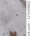 Cement road. Foot can be seen on a cement road. Grey road. 123149802