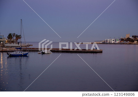 Tranquil Harbor Scene with Boats at Twilight evining time calm sea Tranquil Harbor Scene with Boats at Twilight evining time calm sea 123149806