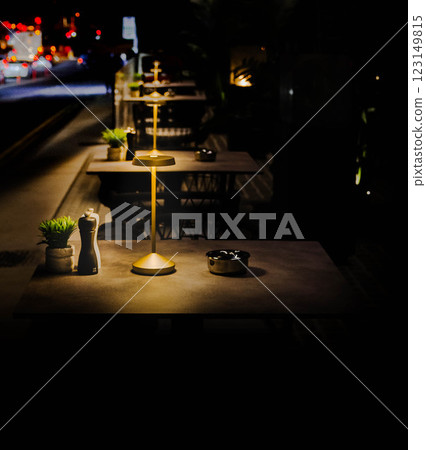 Elegant Outdoor Dining Cozy Lamp-Lit Ambiance Perfect Dinner Setting Elegant Outdoor Dining Cozy Lamp-Lit Ambiance Perfect Dinner Setting 123149815