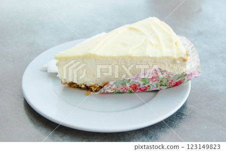 Decadent Cheesecake with White Chocolate on a Sleek Grey Ash Background Decadent Cheesecake with White Chocolate on a Sleek Grey Ash Background 123149823