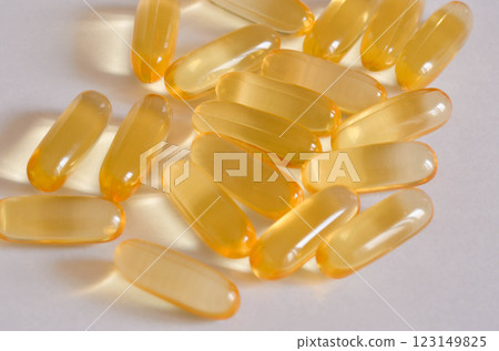 Transparent Softgel Capsules omega3 with Golden Hue on White Background Transparent Softgel Capsules omega3 with Golden Hue on White Background 123149825