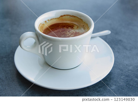 Freshly Brewed Espresso in a White Ceramic Cup on grey ash background A Perfect Start to Your Day 123149830