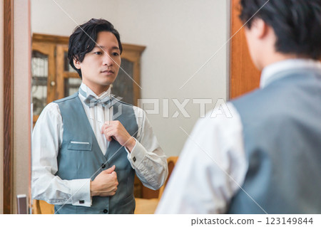 Groom/bridegroom preparing for wedding/ceremony/reception in waiting room/brides room 123149844