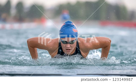 Focused Female Triathlete Swimming in the Rain Inspiring Sport 123149987