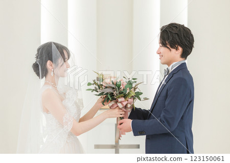 Bride and groom performing bouquet and boutonniere ceremony 123150061