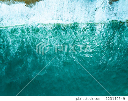 Overhead view turquoise stormy ocean waves with white foam in the ocean,Sea water with splashes and foam, Top view waves background, Natural background photo sea texture with waves soft focus 123150349