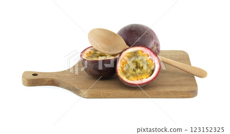 Fresh passion fruits and wooden spoon on cutting board 123152325