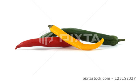 Red, green and yellow chili peppers forming a colorful trio on white background 123152327