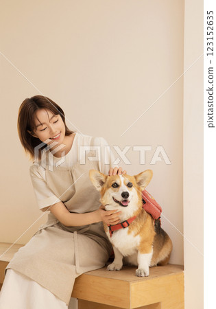 Portrait of a woman sitting with a dog 123152635