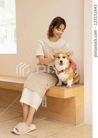 Portrait of a woman sitting with a dog 123152643