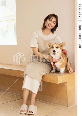 Portrait of a woman sitting with a dog Portrait of a woman sitting with a dog 123152655