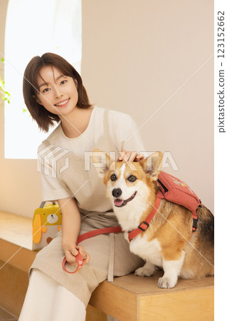 Portrait of a woman sitting with a dog 123152662