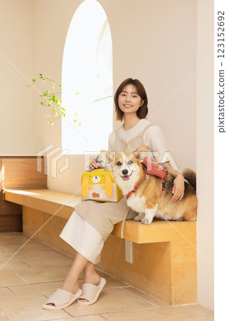 Portrait of a woman sitting with a dog 123152692