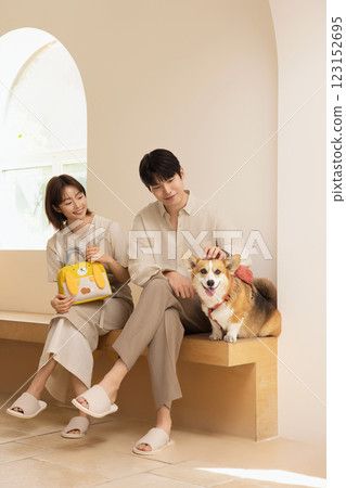 Portrait of a couple sitting with a dog 123152695