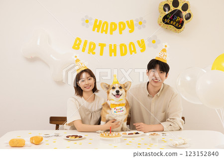 A young couple preparing for their dog's birthday party 123152840