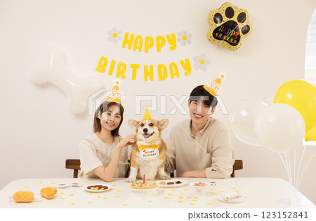 A young couple preparing for their dog's birthday party A young couple preparing for their dog's birthday party 123152841