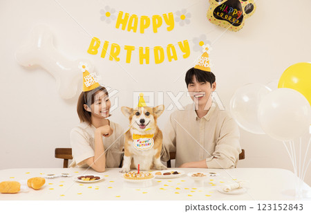 A young couple preparing for their dog's birthday party 123152843