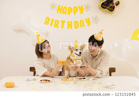 A young couple preparing for their dog's birthday party A young couple preparing for their dog's birthday party 123152845