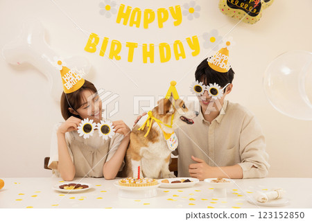 A young couple preparing for their dog's birthday party 123152850
