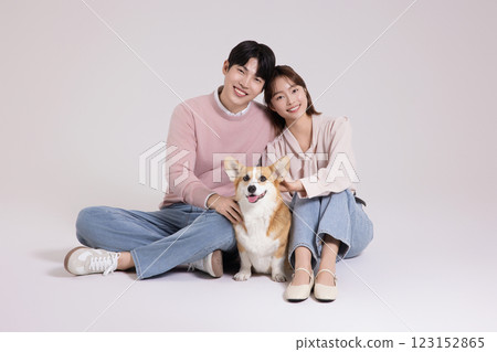 Family photo of a young couple raising a cute Welsh Corgi Family photo of a young couple raising a cute Welsh Corgi 123152865
