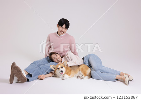 Family photo of a young couple raising a cute Welsh Corgi Family photo of a young couple raising a cute Welsh Corgi 123152867