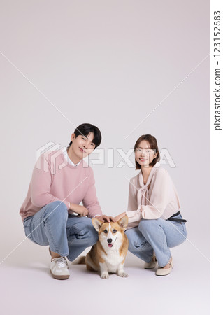 Family photo of a young couple raising a cute Welsh Corgi Family photo of a young couple raising a cute Welsh Corgi 123152883