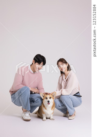 Family photo of a young couple raising a cute Welsh Corgi 123152884