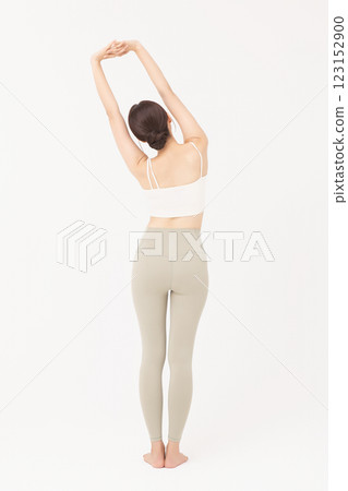 Portrait of young woman stretching in sportswear 123152900