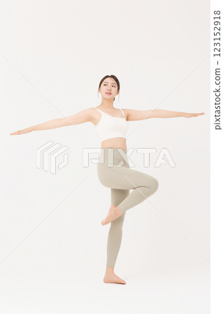 Portrait of young woman stretching in sportswear 123152918