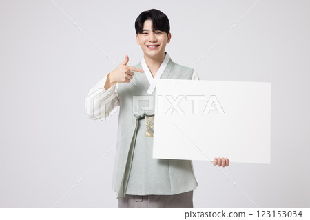 Portrait of a young man wearing hanbok and standing with copy space 123153034